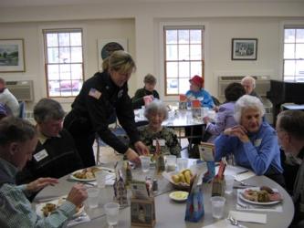 An officer serves citizens at the Reassurance Program luncheon