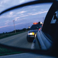 A police car in the rear-view mirror